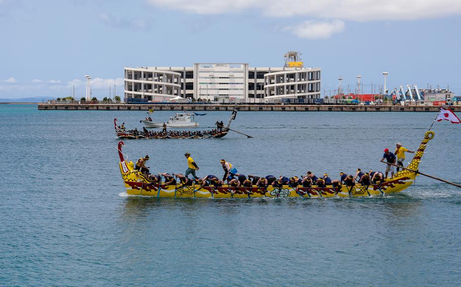 The Army Ladies Dragon Boat Team wins by a razor-thin margin against the Navy Ladies Dragon Boat Team at the Dragon Boat race.